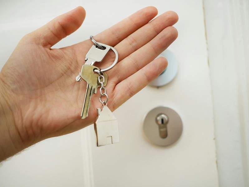 Hand holding house key